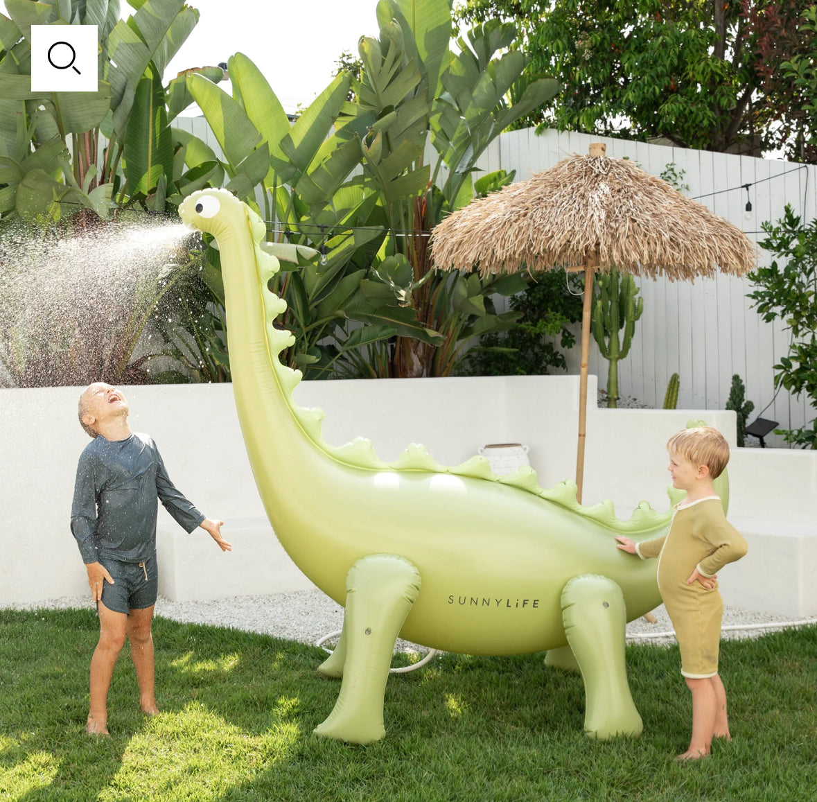 Into The Wild Dino Giant Sprinkler, standing over 6 feet tall. Attach to your garden hose for refreshing water play. Made from durable, non-toxic PVC. Perfect for kids' summer fun with lifelike 3D details. Includes hose adaptor and repair patch.