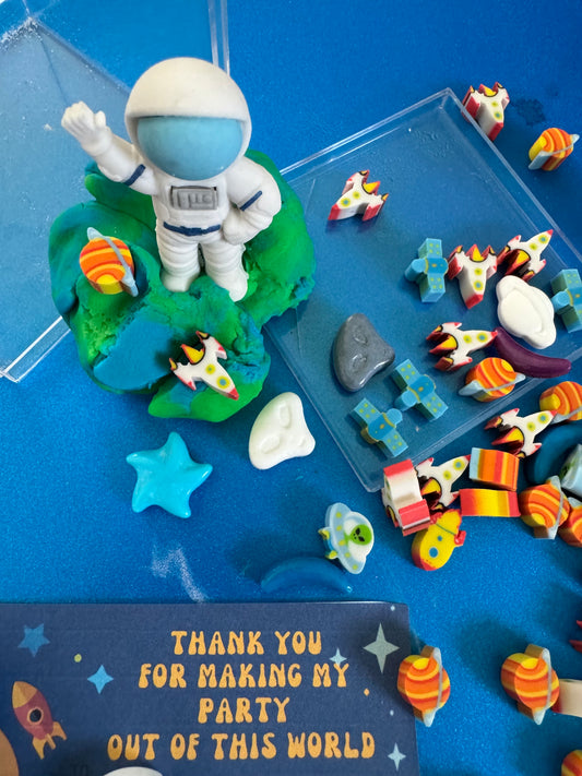 Blast off with this space-themed sensory kit, featuring handmade blue/green swirl glitter dough, space charms, and soft pom poms. Perfect for sensory development and creative play for astronaut enthusiasts. Ideal for kids 3 and up. Choking hazard warning.