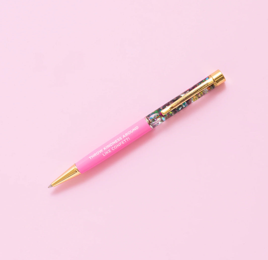 Confetti pen with gold metal accents and the phrase 'Never let anyone dull your sparkle.' Features a medium ballpoint with black ink, liquid-filled with water and confetti inside. Twist pen tip to use. Pairs perfectly with notebooks as a gift. Imported.