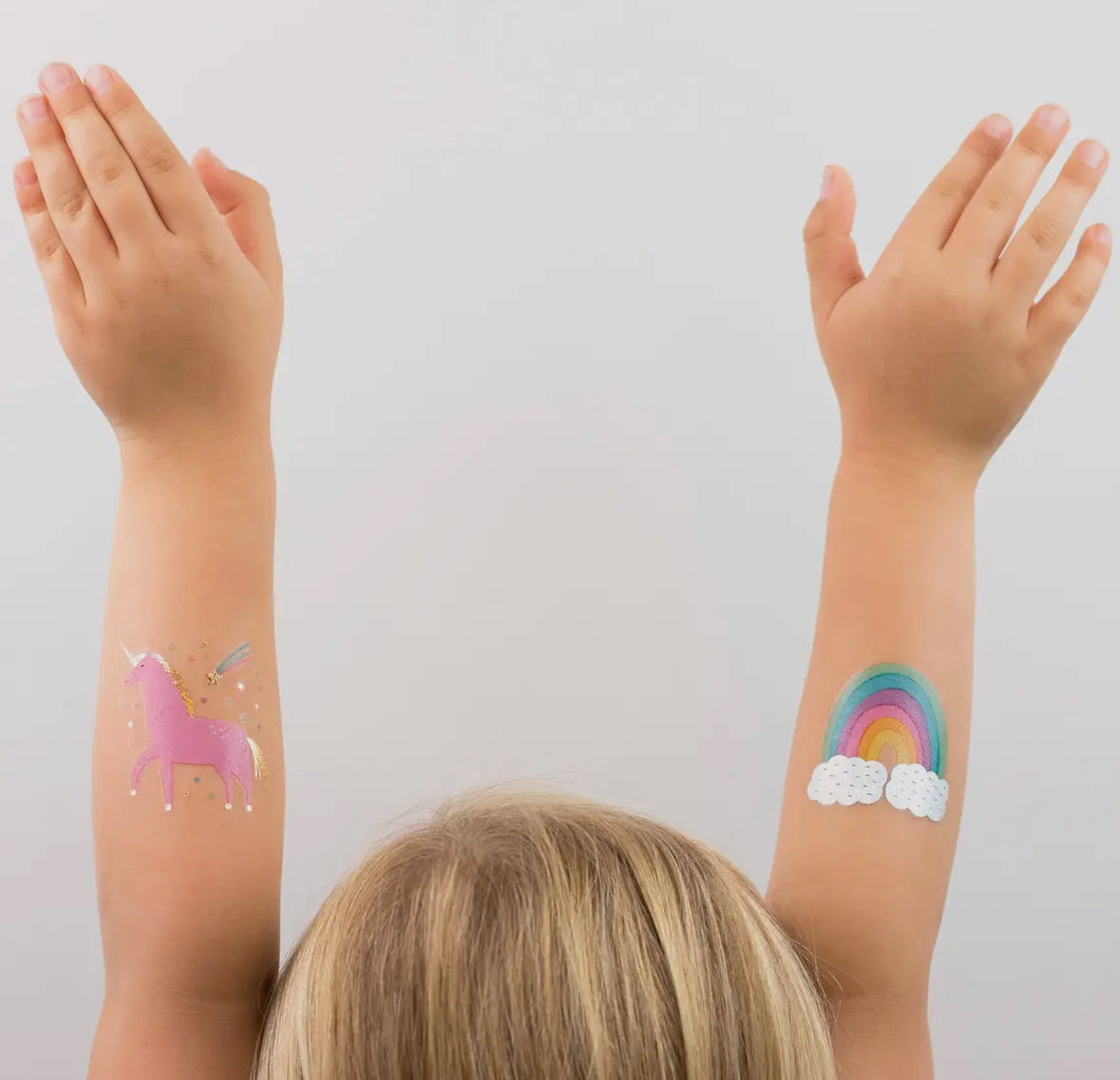 Unicorn and rainbow-themed temporary tattoos with candy-like colors, gold, and holographic silver foil. Illustrated by Hello!Lucky for Daydream Society. Pack includes 2 tattoos (1 of each design), each measuring 2.5 inches square. Safe, non-toxic, and packaged in a card stock envelope