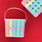 Personalized chalk bucket with 20 pieces of non-toxic chalk, featuring a handle and optional chalk holder. Ideal for outdoor fun or classrooms, easy to clean with water. Includes custom label and wrapping. Perfect for party favors or gifts.