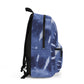 Personalized tie-dye backpack for kids, customizable with initials or name. Featuring a blue tie-dye swirl pattern, this trendy and durable bag includes a water bottle holder, zippered front pocket, and adjustable straps, making it perfect for school or camp.