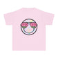 Kids’ summer t-shirt with a leopard print smiley face and watermelon sunglasses. Soft, durable cotton, available in youth sizes XS-XL. Perfect for summer activities.