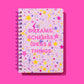 Hardcover notebook with motivational phrase, stars pattern, perforated pages, purple binding.