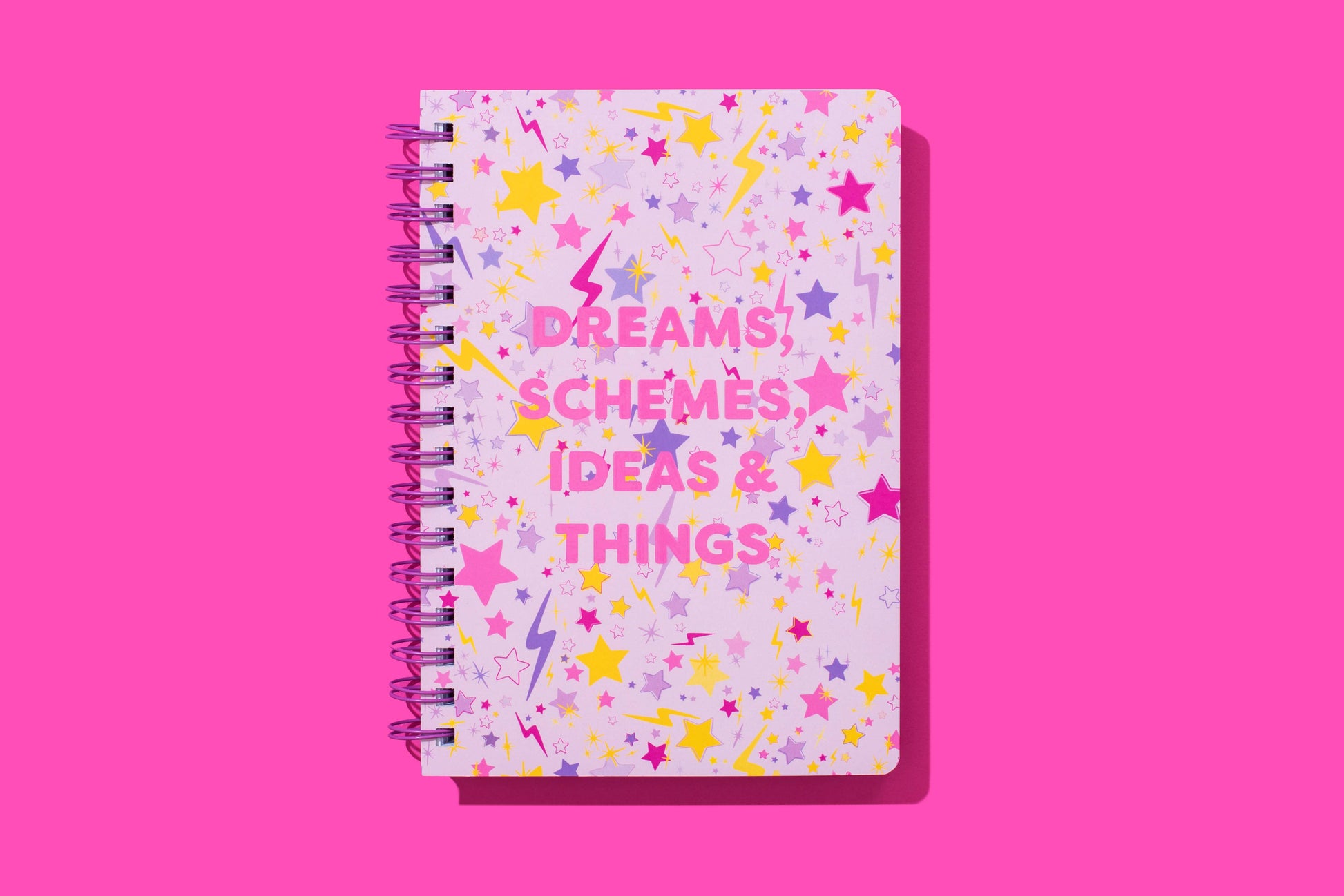 Hardcover notebook with motivational phrase, stars pattern, perforated pages, purple binding.