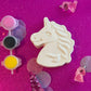 Unicorn-themed DIY paint kits, perfect party favors for kids' events. Each handmade party favor bag includes a mini sculpture, paints, and a paintbrush, encouraging artistic expression in kids aged 3+. Great for birthdays, baby showers, sleepovers, and family reunions. Ideal indoor activity for toddlers and preschoolers, packaged in cute, whimsical designs.