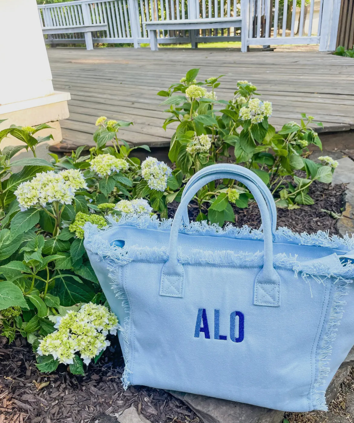 Stylish On the Fringe Tote featuring playful fringe detailing for a fun, fashionable look. Made with high-quality materials, this tote is perfect for spring break, adding a trendy touch to any outfit