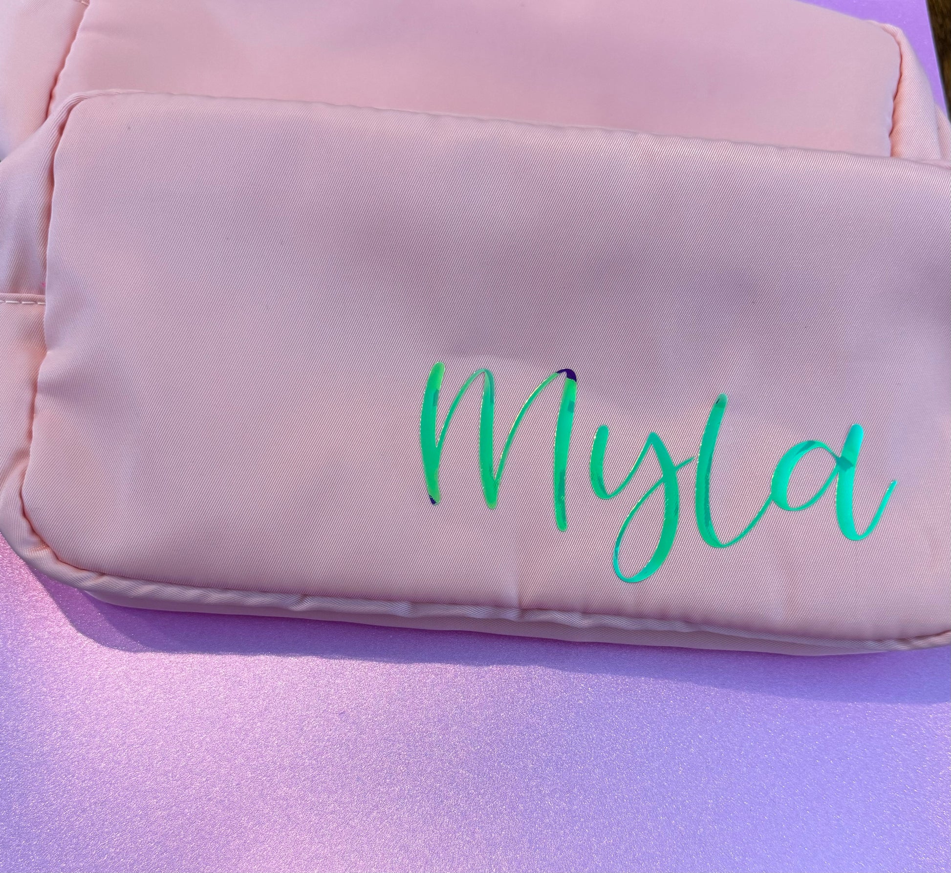 Personalized cosmetic pouch with zipper, featuring custom name, initials, or trendy icons. Lightweight and durable, available in neon or neutral colors with gold zippers. Size: 10" long x 5" wide x 3" deep. Perfect for summer slumber parties, travel, school, or as a makeup organizer. Great gift for girls, bridesmaids, or team members.