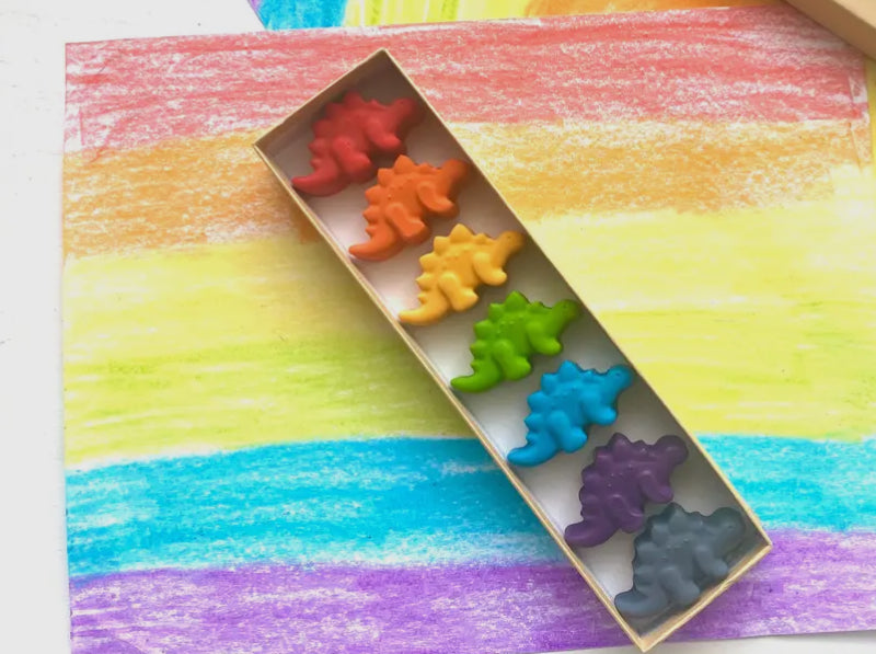 Eco-friendly dinosaur crayons gift set made from recycled materials, featuring 7 non-toxic crayons in assorted colors. Great for parties, holidays, and everyday fun!