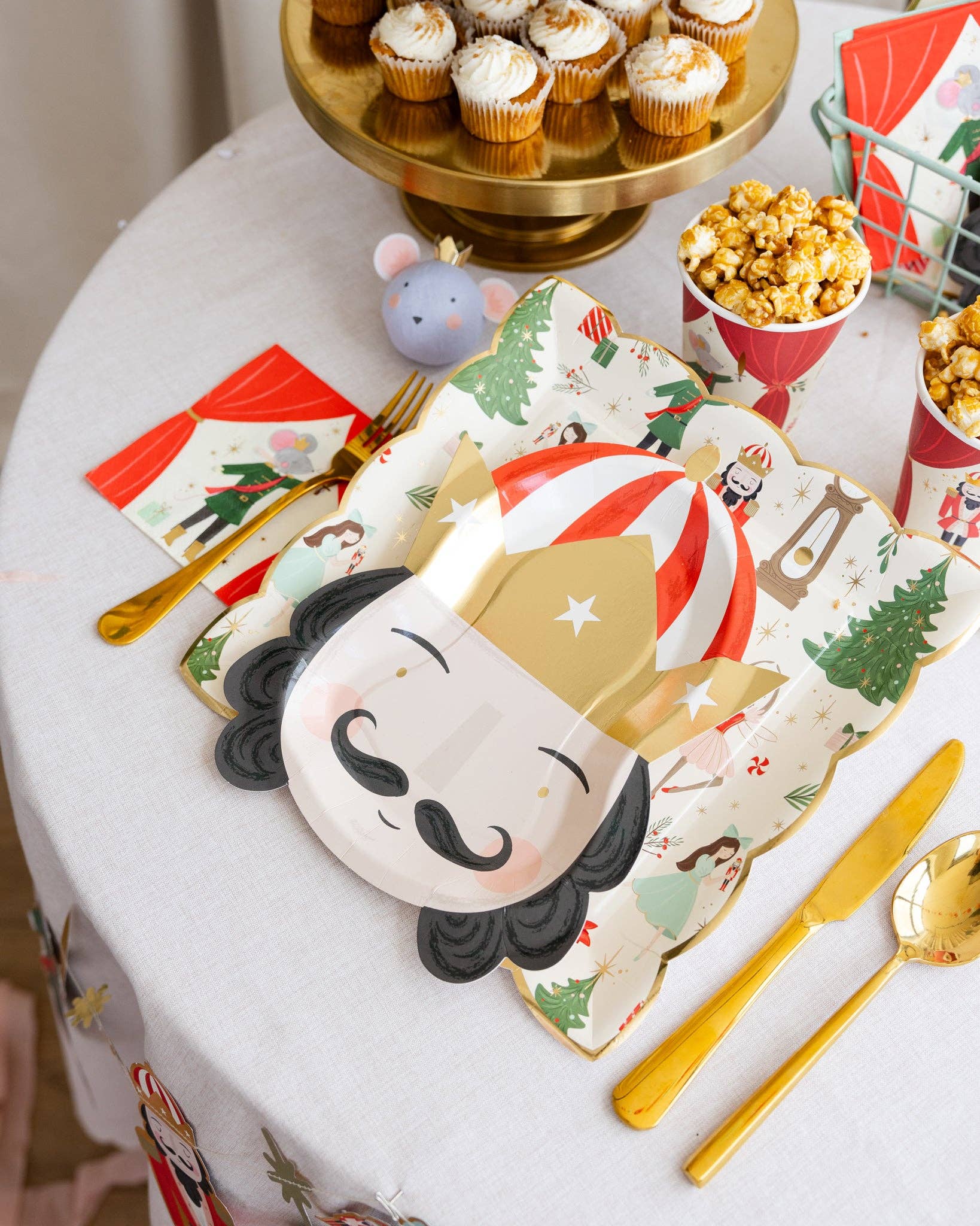 Nutcracker shaped party plates featuring gold foil accents, measuring 7.75" x 10", perfect for serving snacks or desserts at holiday celebrations. Includes 8 plates per set.