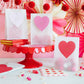 Valentine's Day glassine treat bags with heart-shaped stickers, perfect for gifting candy or small presents, includes 8 bags and 8 heart stickers.