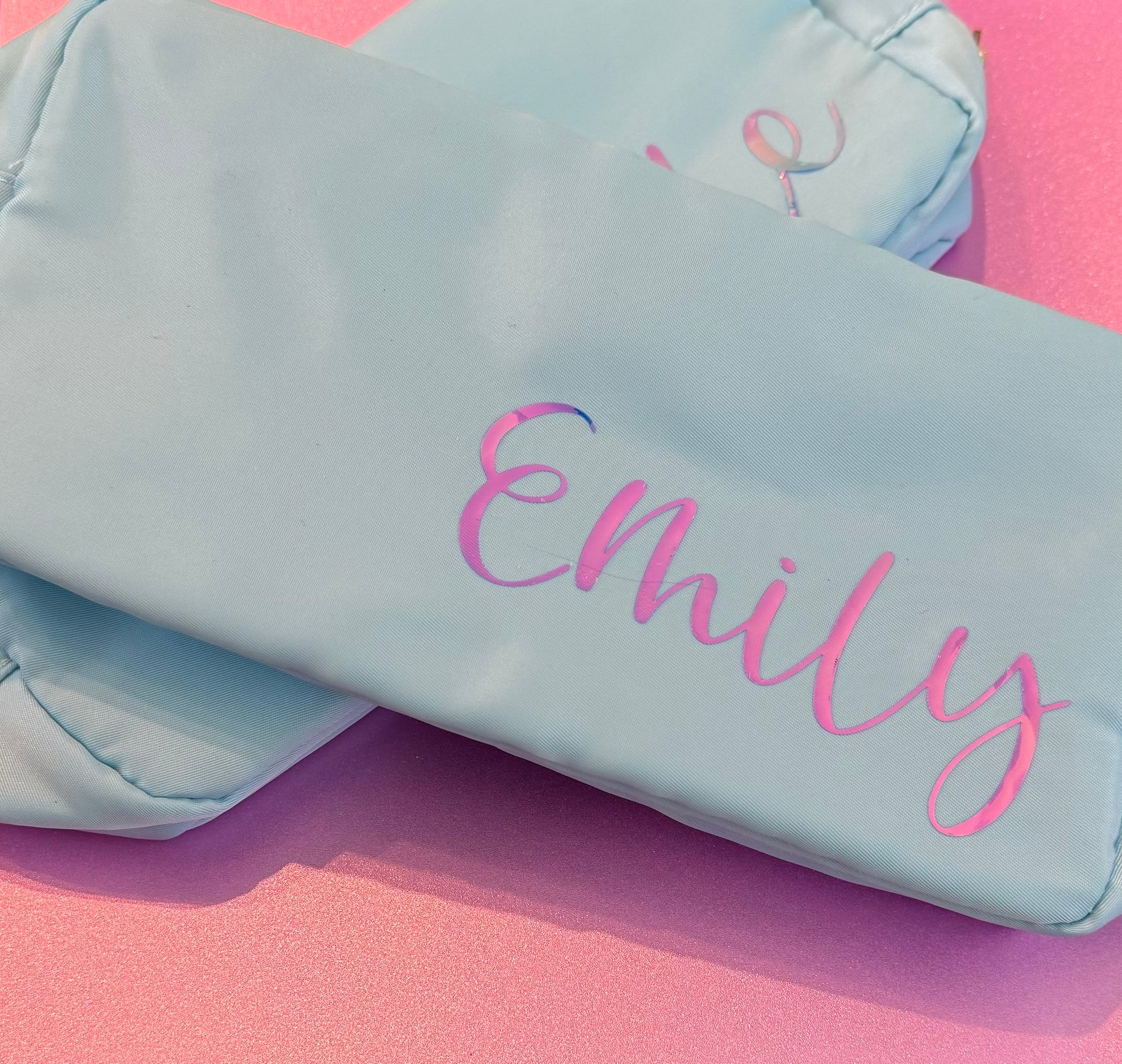 Personalized cosmetic pouch with zipper, featuring custom name, initials, or trendy icons. Lightweight and durable, available in neon or neutral colors with gold zippers. Size: 10" long x 5" wide x 3" deep. Perfect for summer slumber parties, travel, school, or as a makeup organizer. Great gift for girls, bridesmaids, or team members.