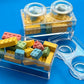 Block-themed candy favor in a brick-shaped box, perfect for birthday parties or playdates. Includes Lego-themed candies with optional cellophane wrap and thank you label. Custom candy containers available upon request.