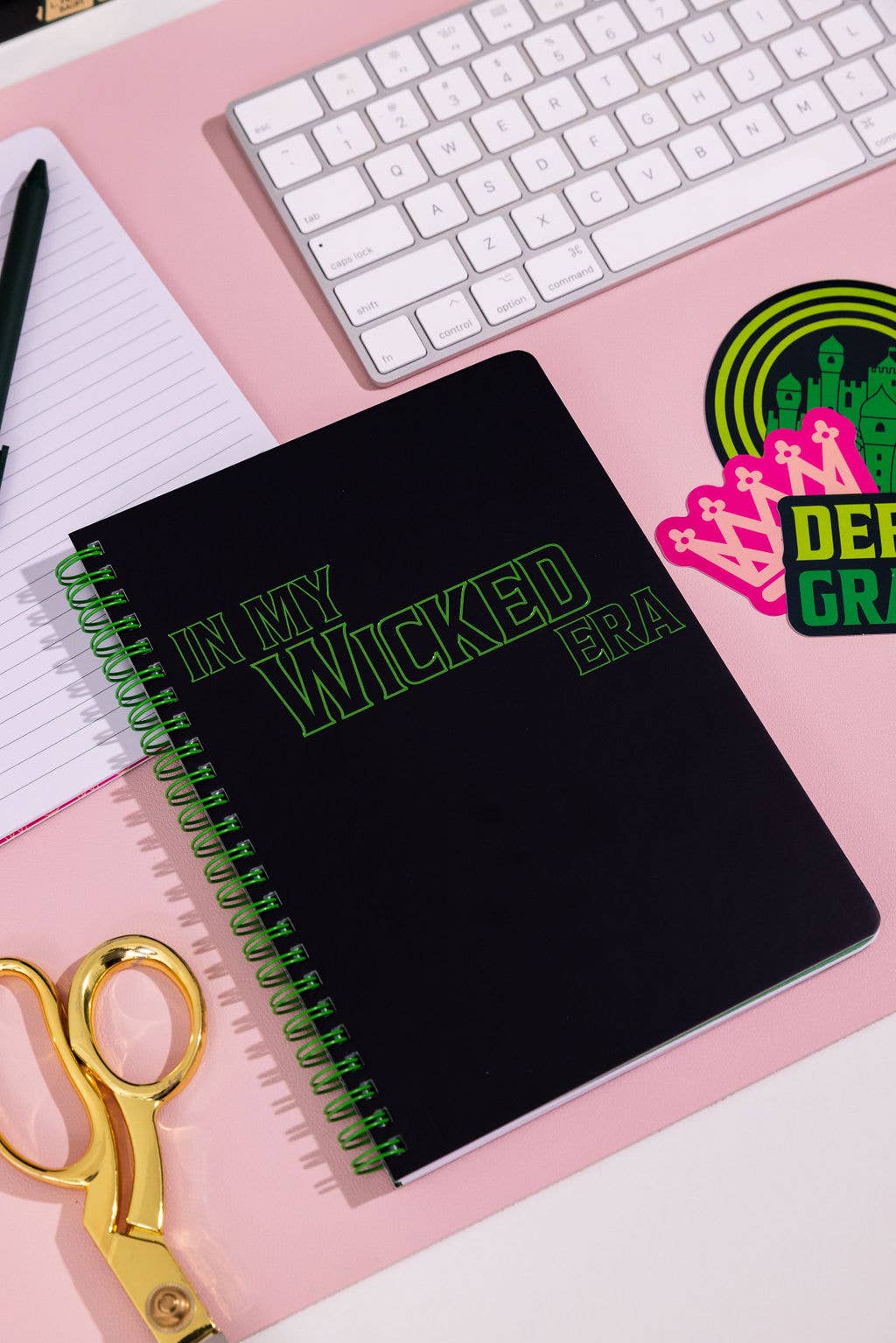 Wicked-inspired mini notebook with 160 college-ruled pages, durable hardcover, and convenient pockets.