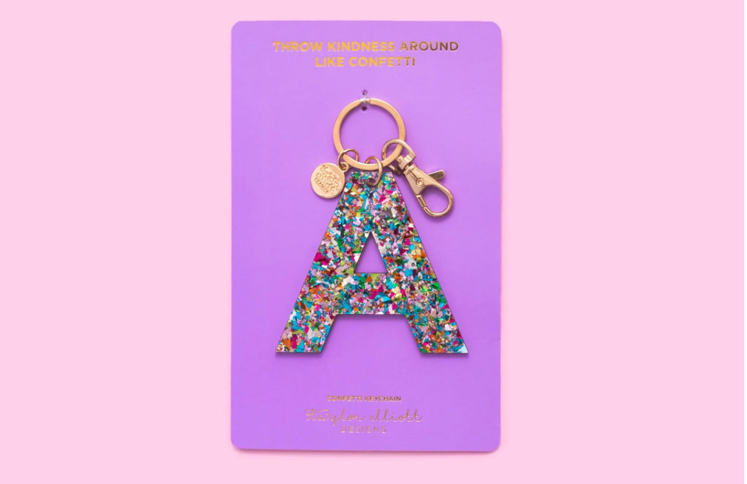 Personalize your accessories with our Confetti Letter Keychains. Each keychain features a 3" x 3" acrylic letter with confetti sprinkled inside, ensuring no shedding. Includes a gold metal keyring and gold foil imprinting on a 3.6" x 6.5" backer card.