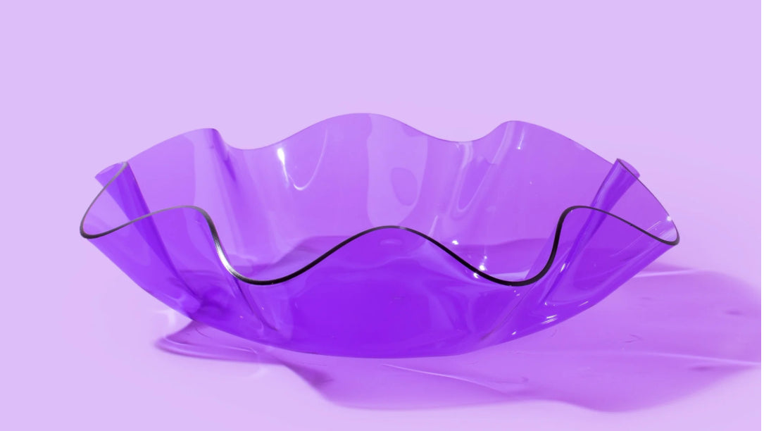 Colorful 8" diameter wavy bowl made of purple acrylic, 3" tall, perfect for parties, desk decor, or as a catch-all bowl. Imported and stylish, ideal for vibrant kitchenware and modern home decor.