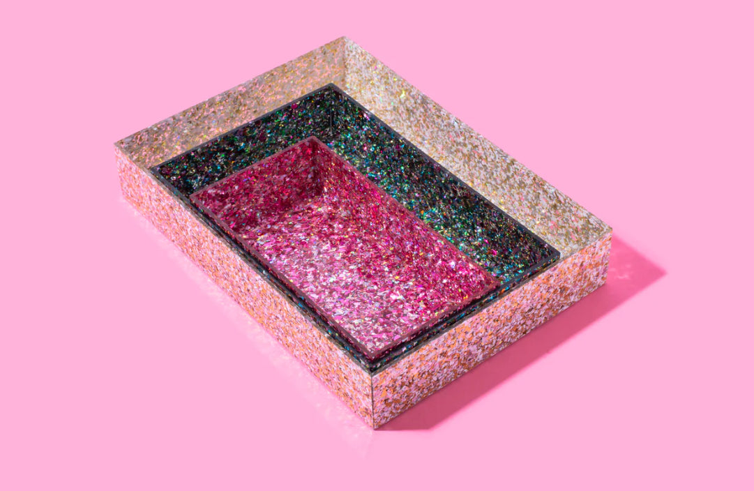 Add sparkle to your home or office with this 12x8 acrylic confetti tray, featuring a 2-inch height and pearl confetti mix. Perfect for guest bathrooms, coffee tables, or as a stylish desk tray. Elevate your decor with this imported, elegant accessory