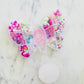 Personalized mini butterfly bead kit with alphabet beads, pearls, iridescent beads, and butterfly beads. Includes pink and clear string for creating your own bracelets or necklace. Perfect for kids' crafts and gifts. Warning: contains small parts.