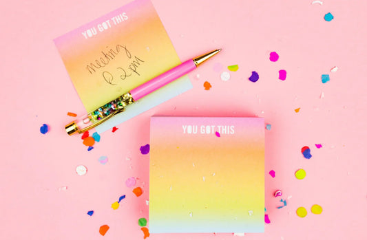 Colorful sticky notes measuring 3.5" x 3.5", featuring the inspirational phrase 'You Got This.' Each pad includes 300 sheets with a sticky adhesive backing, shrink-wrapped for packaging. Perfect for adding fun to your workday. 