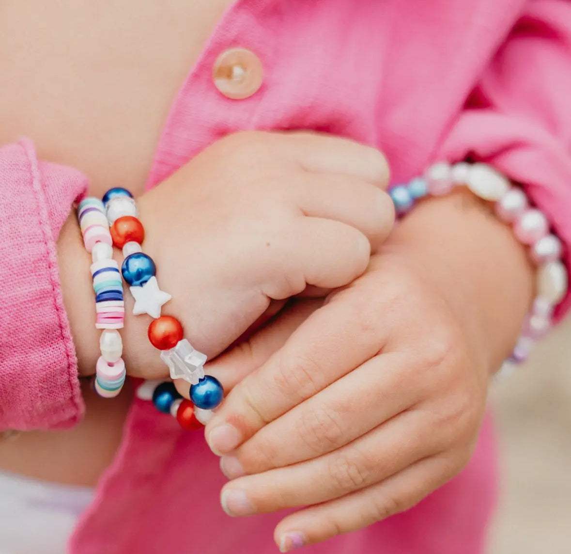 DIY jewelry bead kit featuring red, white, clear, and pearl beads, along with glitter alphabet beads and pink and clear string. Perfect for creating bracelets or necklaces. Made by a small, women-owned business. Warning: contains small parts.