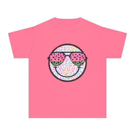 Kids’ summer t-shirt with a leopard print smiley face and watermelon sunglasses. Soft, durable cotton, available in youth sizes XS-XL. Perfect for summer activities.