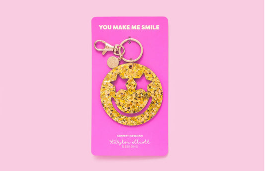 Cheerful Smiley Stars Confetti Keychain, perfect for gifts or personal use. Features a gold metal keyring and silver hologram foil backer card for added flair.