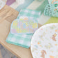 Easter-themed large napkins featuring pastel eggs in blue basket, pack of 16, 4.5x5.5 inches; perfect for spring brunches and garden parties.