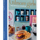 Gilmore Girls: The Official Cookbook featuring over 50 recipes from Stars Hollow, including Sookie’s Risotto, Mrs. Kim’s Flaxseed Muffins, Luke’s Cheeseburger, and coffee tips from Lorelei and Rory, with clever cooking and hosting advice from beloved characters.