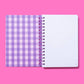 Hardcover notebook with motivational phrase, stars pattern, perforated pages, purple binding.