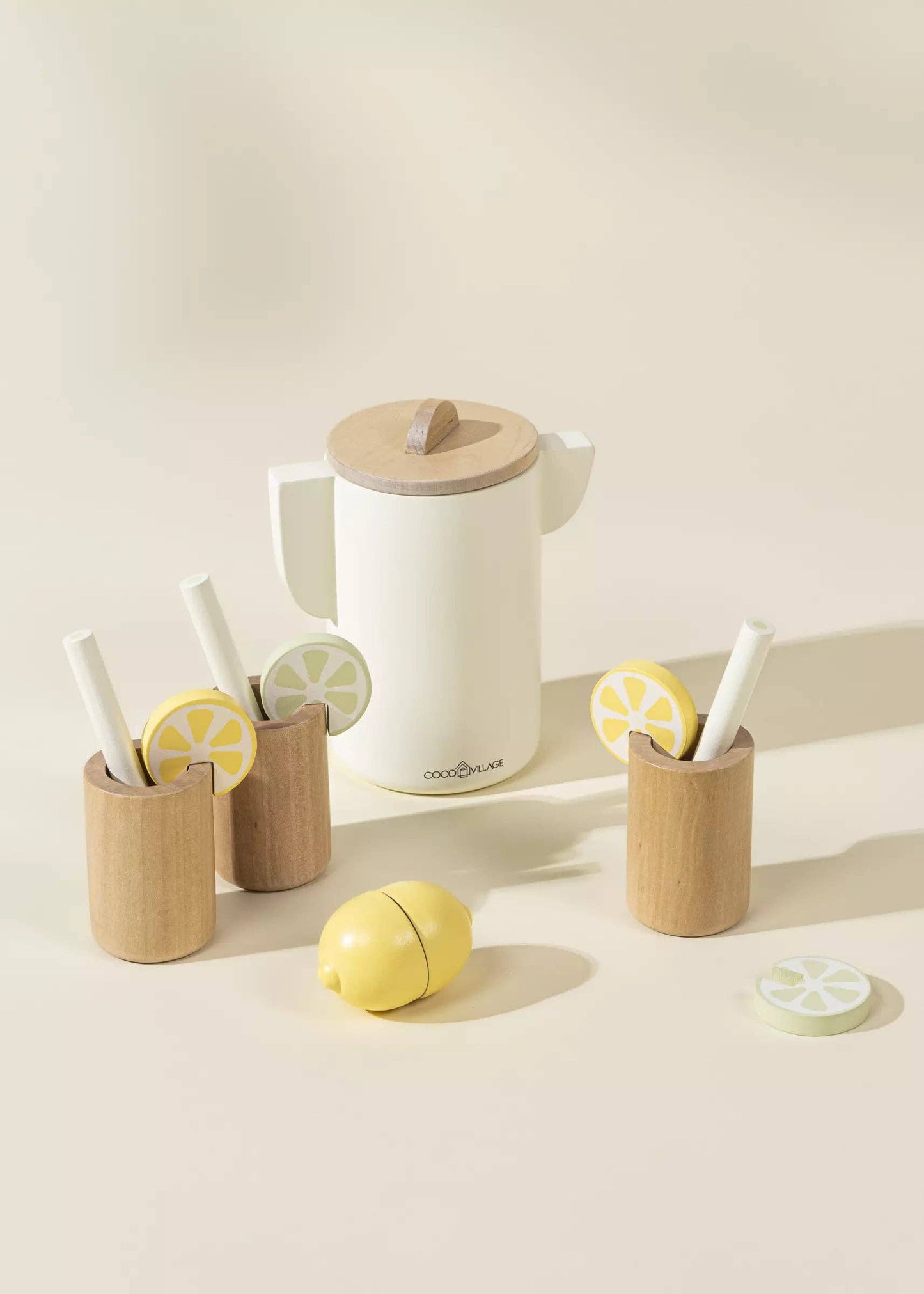 Wooden Lemonade Playset for kids featuring 3 glasses, 3 straws, pitcher, lime and lemon slices, and a cuttable lemon. Perfect for imaginative play, fostering creativity, cognitive development, and role-play as they run their own lemonade stand.