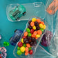 Car-themed candy favors, perfect for birthdays or playdates. Includes car-themed gummies or rainbow Skittles in a car-shaped box. Wrapped in cellophane with optional thank you label. Fun and delicious treat for any party. Custom candy containers available.