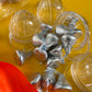 Construction-themed candy favor in plastic helmet containers with chocolate kisses and themed labels. Wrapped in cellophane with optional thank you label. Ideal for construction-themed parties and events.