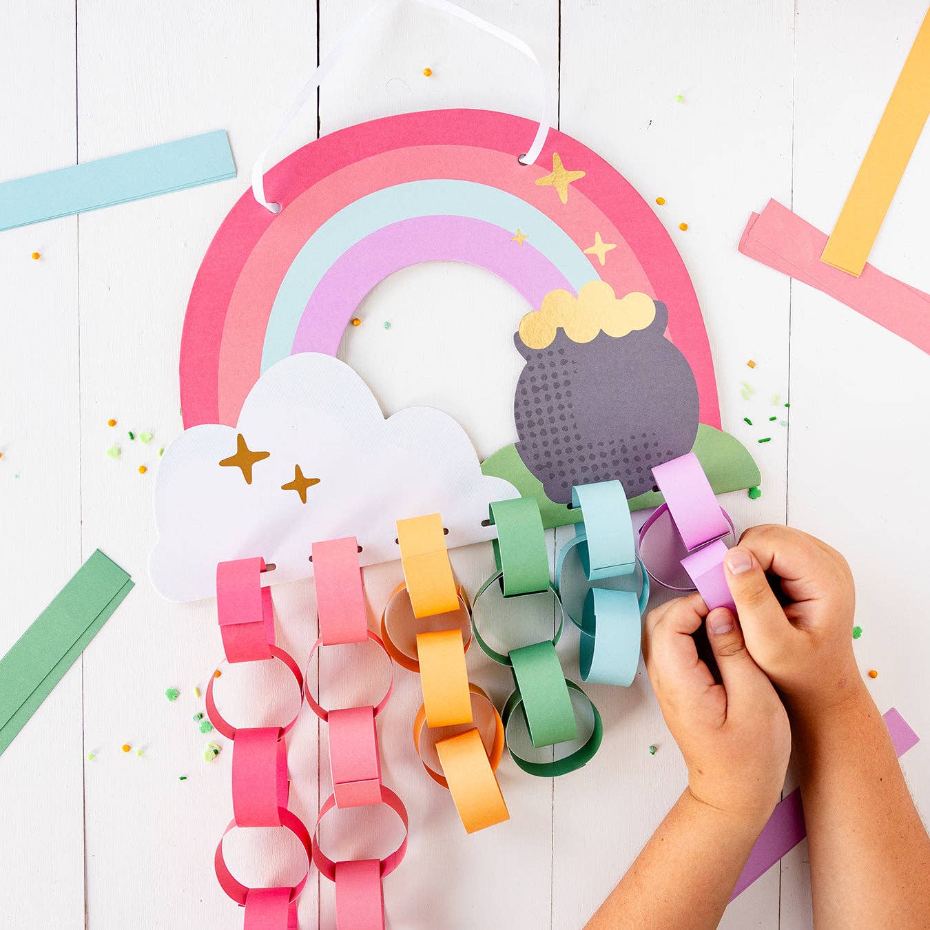 Rainbow Paper Chain Project – includes chipboard rainbow, ribbon, 48 paper pieces with gold foil, perfect for St. Patrick's Day crafts.