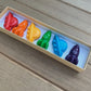 Awesome space-themed crayon gift set containing 6 non-toxic crayons in an 8" x 2" box. Perfect for stocking stuffers, Easter baskets, party favors, and classroom gifts. Made from recycled and upcycled materials, featuring assorted colors including red, green, blue, and more.