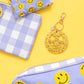 Cheerful Smiley Stars Confetti Keychain, perfect for gifts or personal use. Features a gold metal keyring and silver hologram foil backer card for added flair.