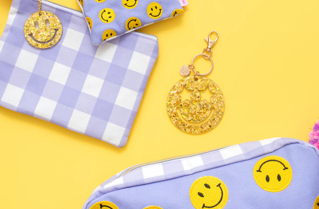 Cheerful Smiley Stars Confetti Keychain, perfect for gifts or personal use. Features a gold metal keyring and silver hologram foil backer card for added flair.