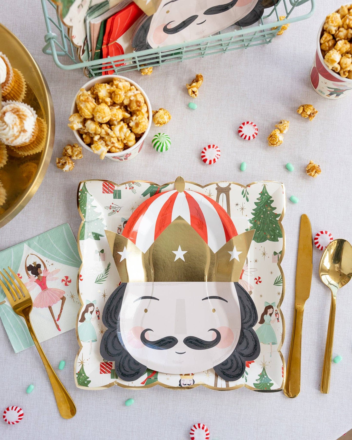 Nutcracker shaped party plates featuring gold foil accents, measuring 7.75" x 10", perfect for serving snacks or desserts at holiday celebrations. Includes 8 plates per set.