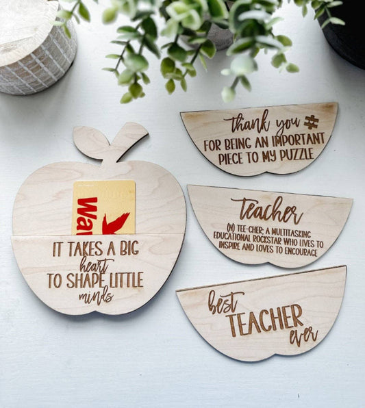 Laser-engraved apple-shaped wooden gift card holder with four customizable engravings: 'Best Teacher Ever,' 'It Takes a Big Heart to Shape Little Minds,' 'Thank You for Being an Important Piece to My Puzzle,' and 'Teacher Definition.' Made from high-quality 1/8" wood, this thoughtful gift is perfect for teachers and ideal for holidays, Teacher Appreciation Week, or end-of-year gifts.