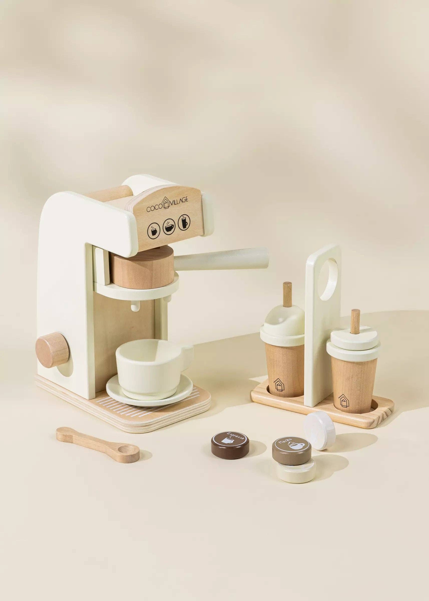 Wooden Coffee Maker Playset for kids with 4 coffee pods, cup, plate, spoon, cup holder, and 2 to-go cups. Perfect for imaginative play, allowing children to role-play as baristas, creating cappuccinos, lattes, and more. Encourages creativity and motor skills development.