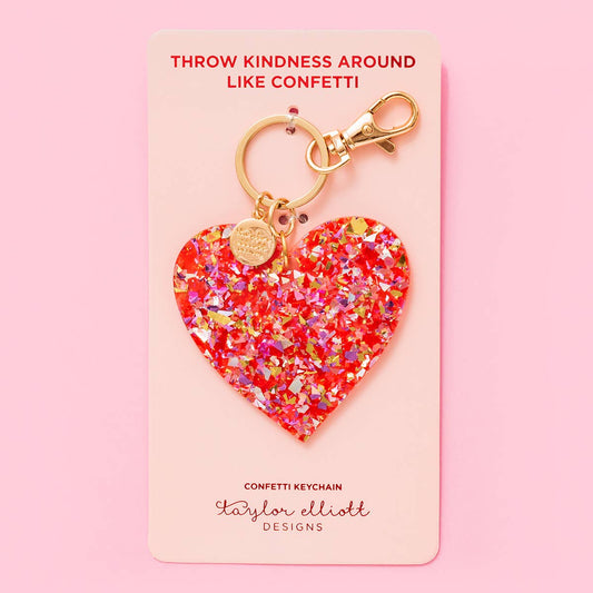 a heart shaped keychain on a pink background