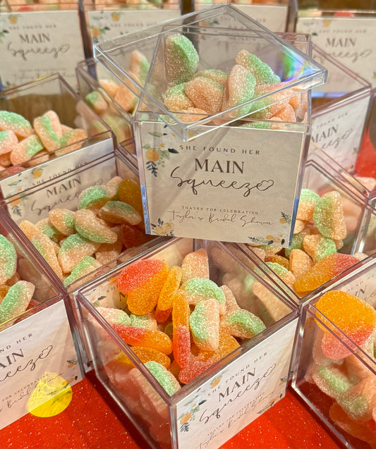 Citrus-themed party favors with the phrase 'You're my Main Squeeze,' perfect for birthdays and bridal showers. Includes candy and a custom tag for a personal touch, adding a fun and playful element to your event.