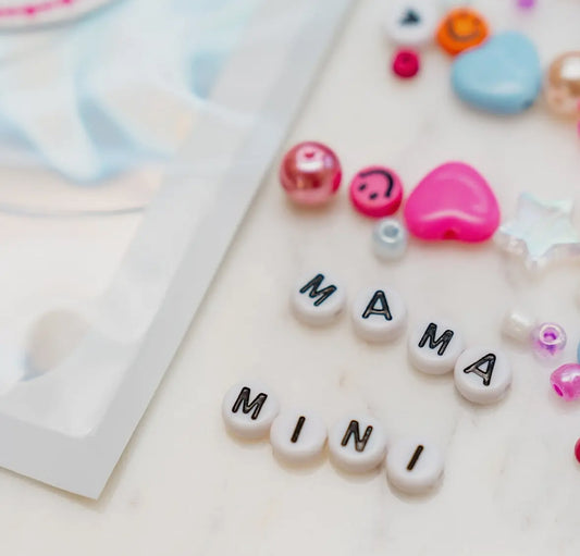 Mama and Mini bead kit for creating two bracelets or necklaces, one for you and one for your BFF. Includes a variety of beads and clear string. Made by women-owned business, small STACKS. Warning: contains small parts, suitable for kids' craft activities