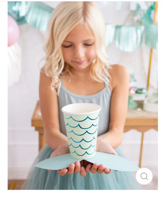 Mermaid Tail Paper Party Cups with adhesive tail and aqua foil accents, perfect for under-the-sea themed celebrations. Includes 8 cups per package, 12 oz capacity, measuring 4.5" tall and 3.5" round at the top