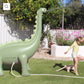 Into The Wild Dino Giant Sprinkler, standing over 6 feet tall. Attach to your garden hose for refreshing water play. Made from durable, non-toxic PVC. Perfect for kids' summer fun with lifelike 3D details. Includes hose adaptor and repair patch.