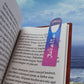 Personalized aluminum bookmark designed for avid readers, featuring a sleek white front and top slot to securely hold pages. This customizable bookmark is perfect as a unique gift for book lovers and adds a touch of style to any reading session. Assembled in the USA from durable materials