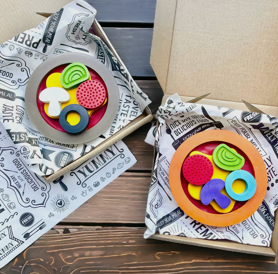 Colorful pizza-shaped crayon gift set, made from 100% non-toxic materials. Perfect for stocking stuffers, party favors, or classroom gifts, each set includes one crayon packaged in a 5" x 5" box. Colors include red, green, blue, yellow, orange, purple, pink, gray, black, and brown, with an assortment varying from the picture.