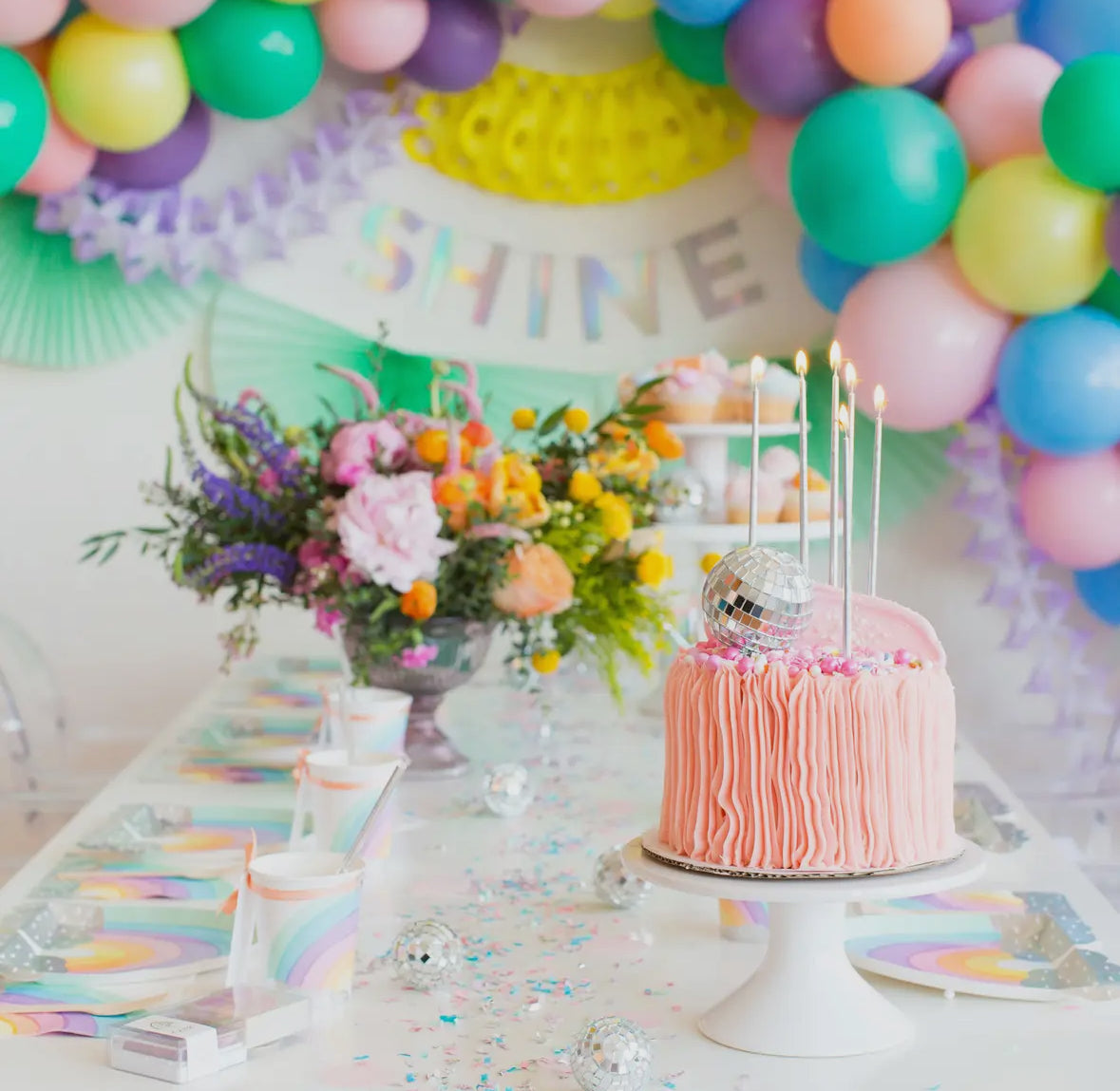 Radical rainbow paper napkins and cups set illustrated by Hello!Lucky for Daydream Society, featuring candy-like colors and glittery silver holographic foil-pressed clouds. The package contains 8 napkins and cups with a 9 oz. capacity, each cup measuring approximately 3.5 inches tall and 3 inches wide. Suitable for hot or cold beverages, withstanding temperatures up to 90-100°F. Not safe for microwave use.