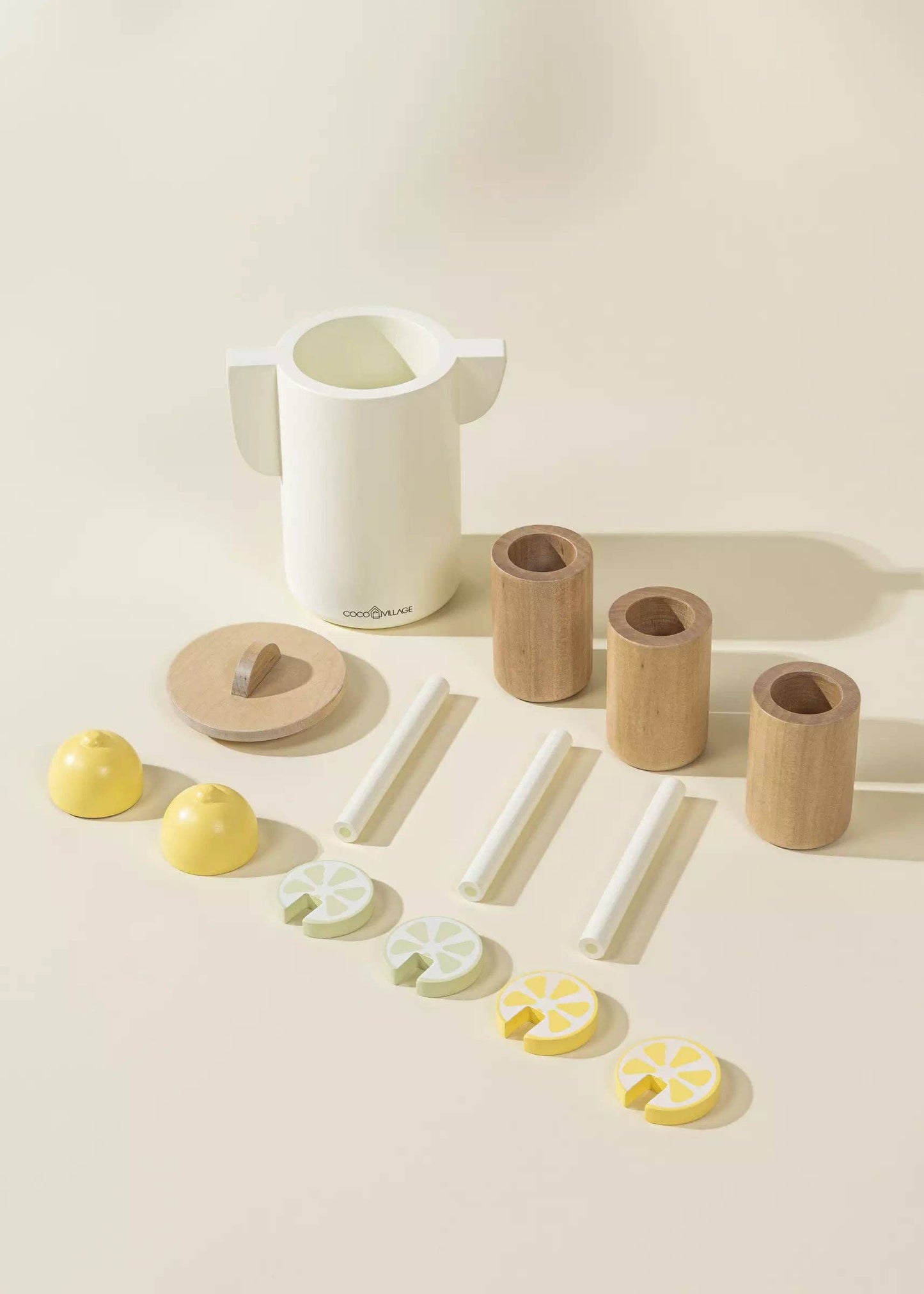 Wooden Lemonade Playset for kids featuring 3 glasses, 3 straws, pitcher, lime and lemon slices, and a cuttable lemon. Perfect for imaginative play, fostering creativity, cognitive development, and role-play as they run their own lemonade stand.