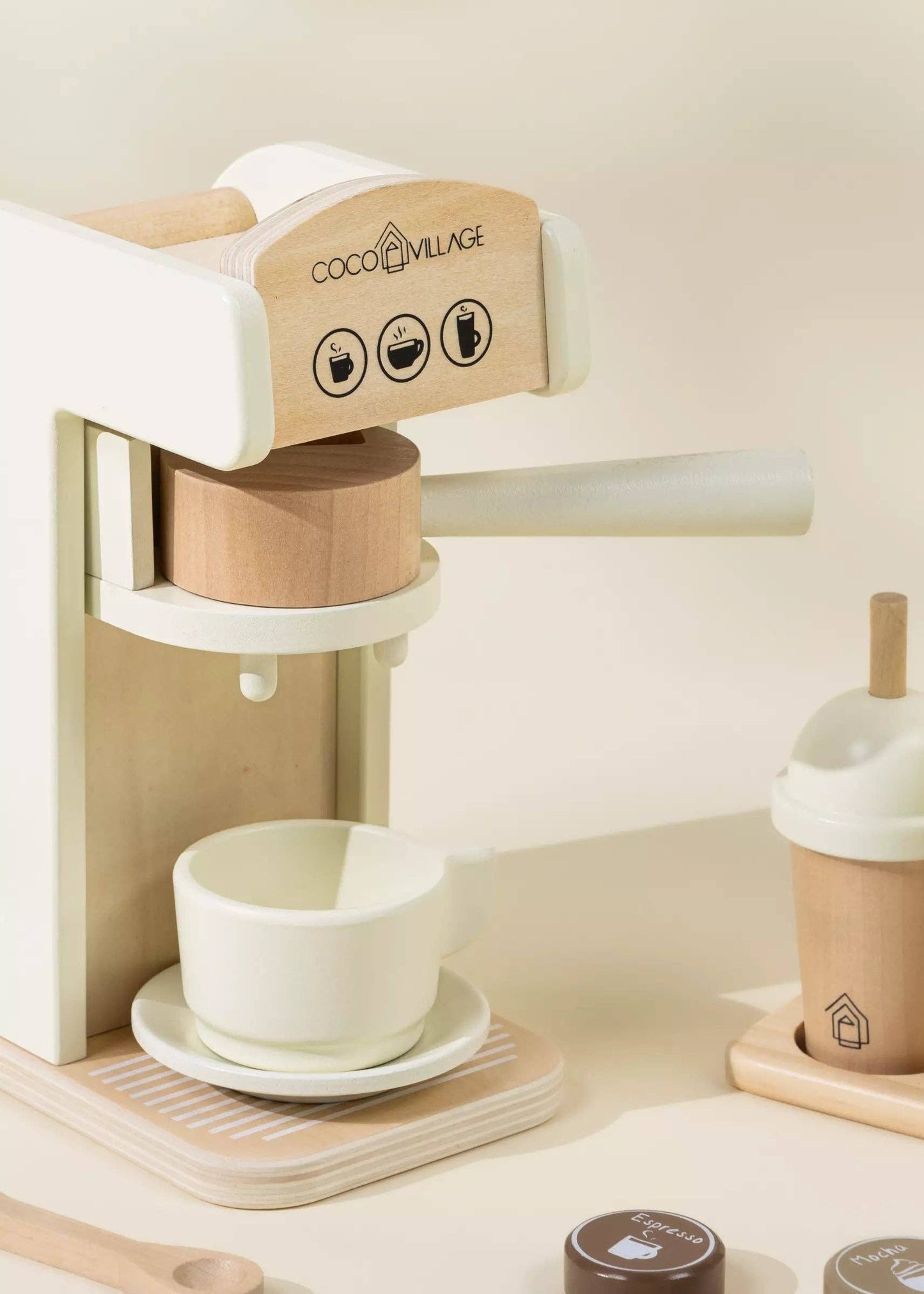 Wooden Coffee Maker Playset for kids with 4 coffee pods, cup, plate, spoon, cup holder, and 2 to-go cups. Perfect for imaginative play, allowing children to role-play as baristas, creating cappuccinos, lattes, and more. Encourages creativity and motor skills development.