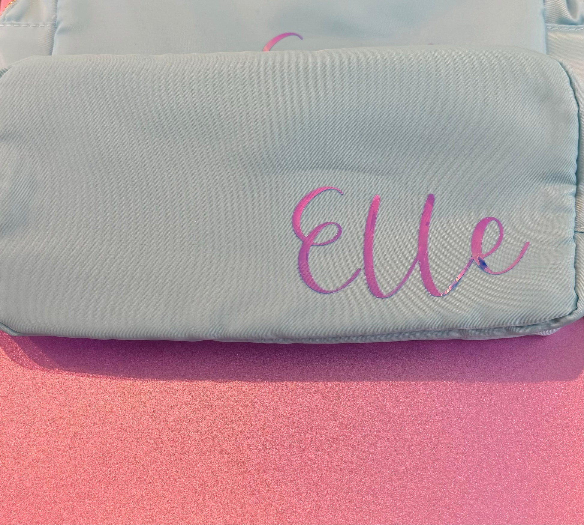 Personalized cosmetic pouch with zipper, featuring custom name, initials, or trendy icons. Lightweight and durable, available in neon or neutral colors with gold zippers. Size: 10" long x 5" wide x 3" deep. Perfect for summer slumber parties, travel, school, or as a makeup organizer. Great gift for girls, bridesmaids, or team members.